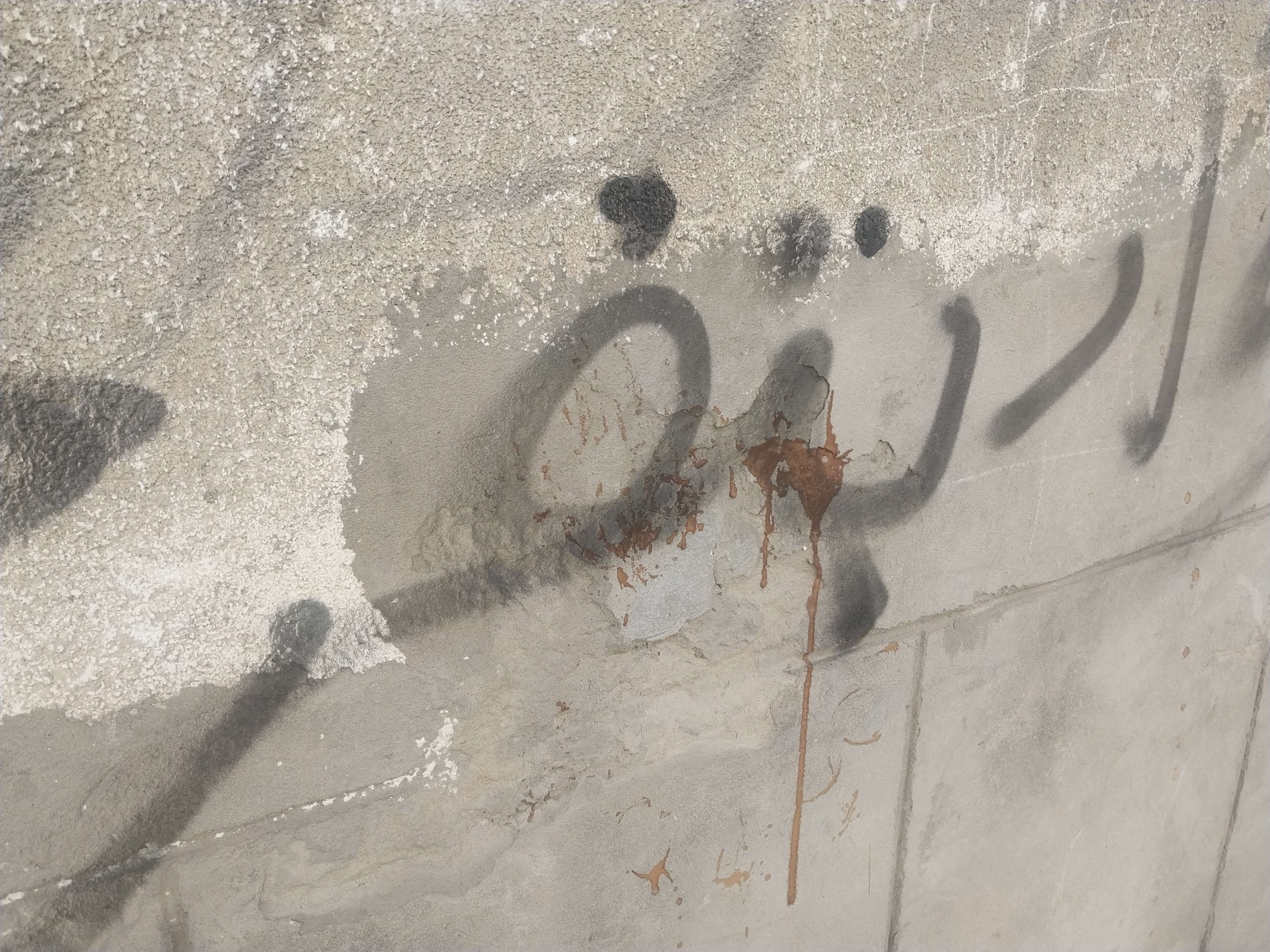 "PortFouad is happy" written on a random wall with some coffee spill on it